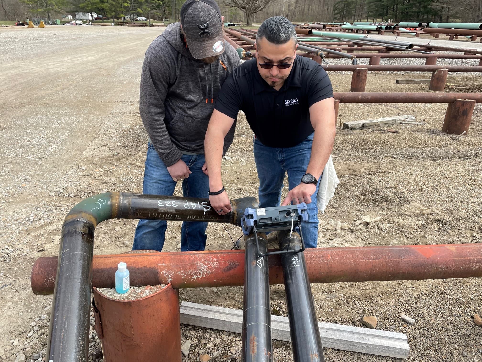 Instructor guiding students through ultrasonic testing
